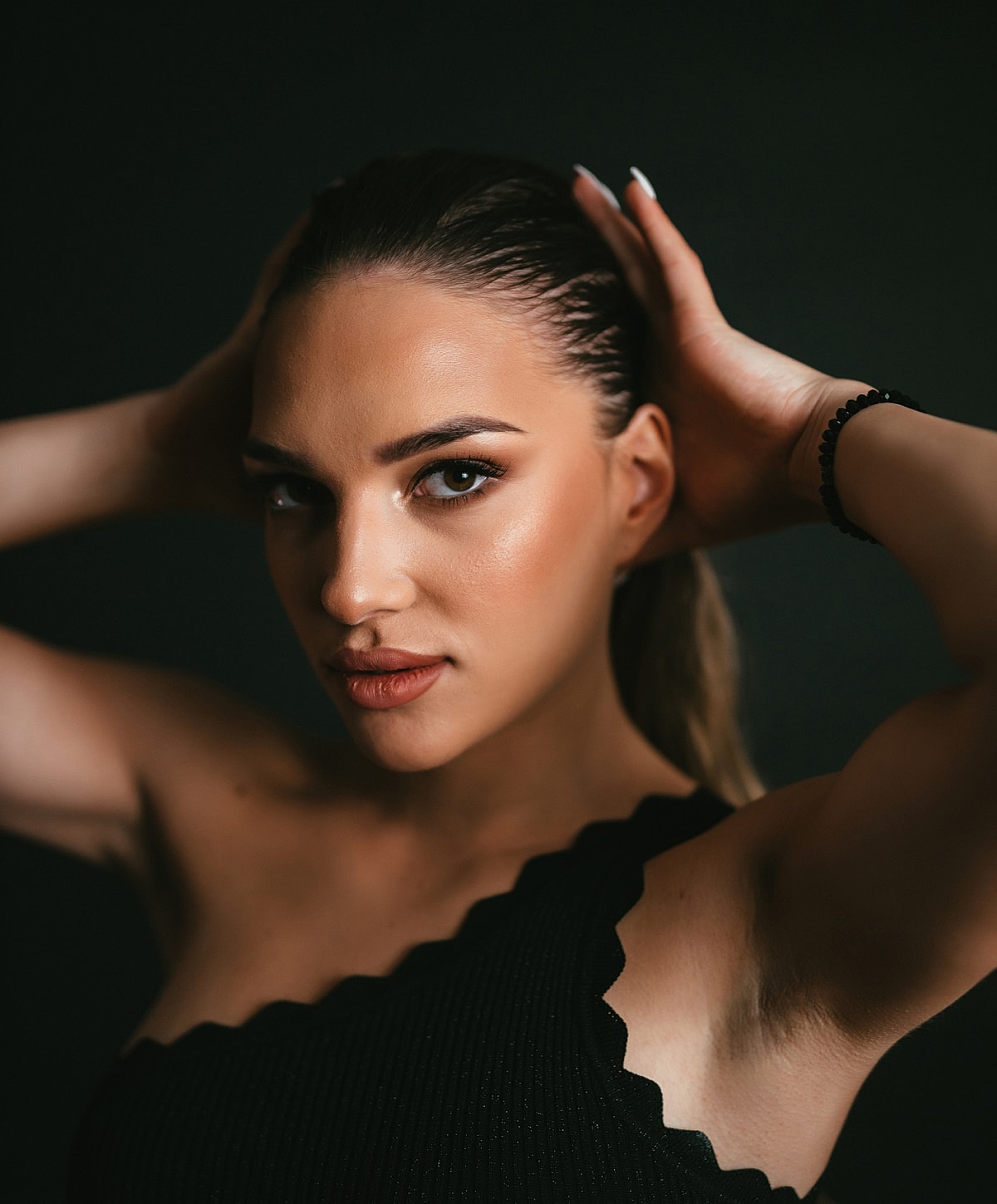 NYC Nasal Reconstruction model with long hair posing against dark background