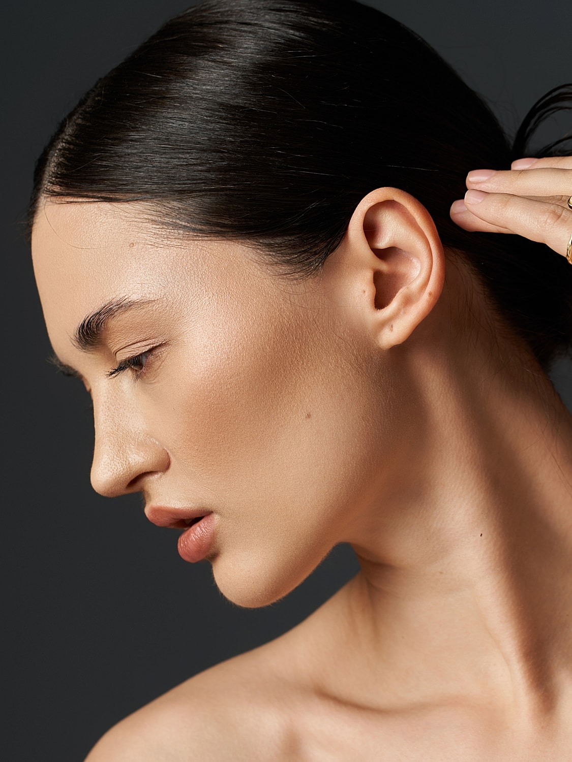 NYC plastic surgery model with sleek hair.