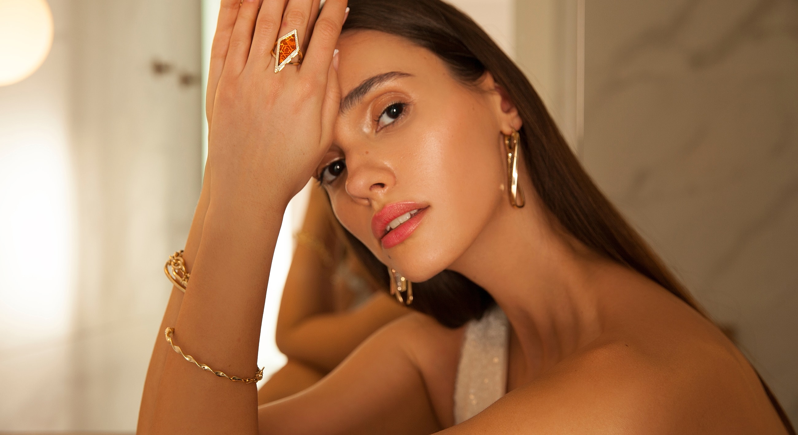 Woman showcasing elegant jewelry and natural beauty